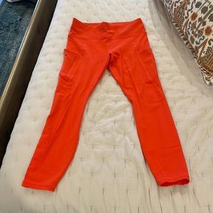 Athleta 7/8 length bright orange leggings. Size medium